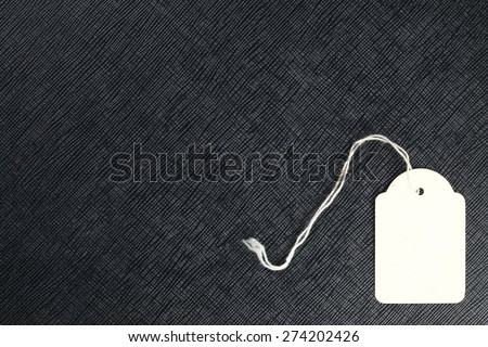 Old paper blank data price tag with white fabric rope represent the price information tool concept related idea.