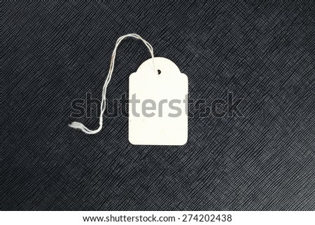 Old paper blank data price tag with white fabric rope represent the price information tool concept related idea.