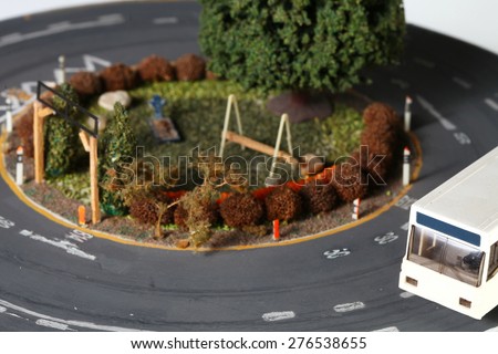 Vintage and classic style miniature model railway layout in the scene appear the park and bus scenic represent the model railway and model making related idea concept.
