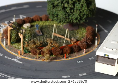 Vintage and classic style miniature model railway layout in the scene appear the park and bus scenic represent the model railway and model making related idea concept.