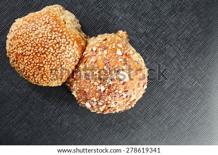 Sesame bread and whole grain bread represent the food and bakery concept related idea.
