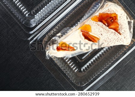 Coffee meringue in the food grade plastic containing box represent the bakery dessert and food concept related idea.
