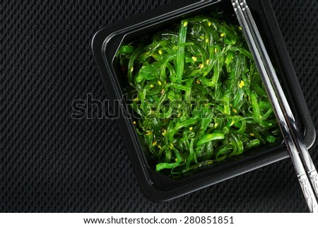 Japanese seaweed salad with shiny stainless chopsticks represent the Japanese food and cuisine concept related idea.