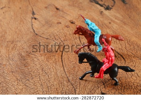 Miniature horse and red indian plastic toy model represent the toy concept related idea.