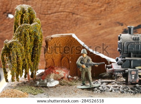Vintage and classic miniature model railway scene appear the German locomotive and soldier figure represent the model railway concept related idea. Super macro and intention focus at the locomotive.