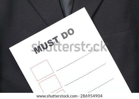 Blue color suit and the printed paper with text appear the word and blank table represent the business concept related idea.