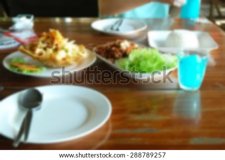 Blurry photo of food and beverage on restaurant table scene represent the background concept related idea.