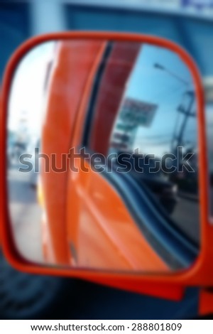 Blurry car side mirror scene represent the car part concept related idea.