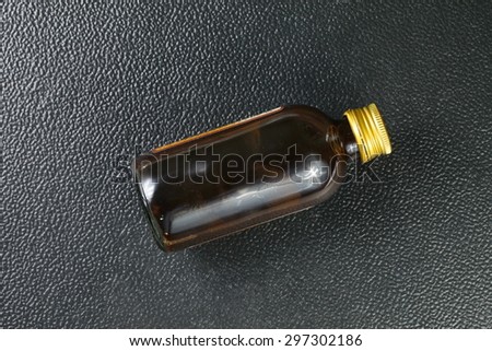 Brown color bottle with gold color metal lid represent the medicine containing bottle concept related idea.