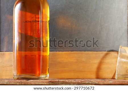 Liqour bottle and dirty shot glass represent the liquor and alcohol beverage background concept related idea.
