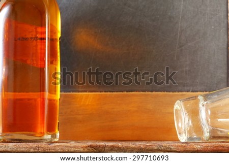 Liqour bottle and dirty shot glass represent the liquor and alcohol beverage background concept related idea.