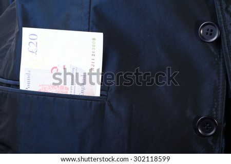 Blue color shirt suit with Great Britain pound banknote inside the pocket.