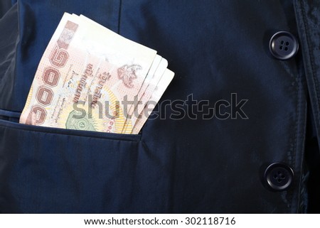 Blue color shirt suit with Thailand banknote inside the pocket.