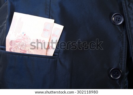 Blue color shirt suit with Thailand banknote inside the pocket.