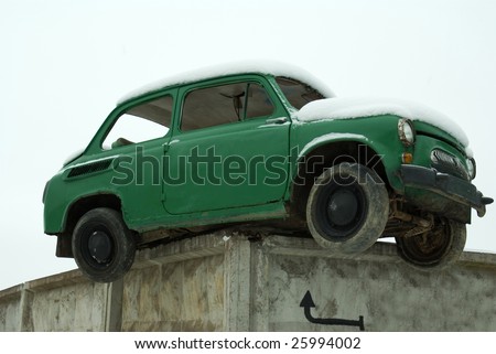Old car green installed on the concrete fence