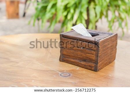 Wooden vintage tissue box on the wood table in shallow depth of field.