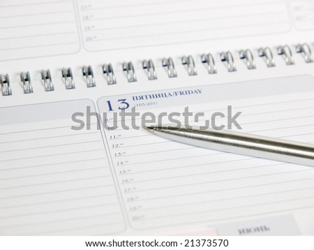 blank calendar with spiral binding and pen closeup.friday 13. shallow dof
