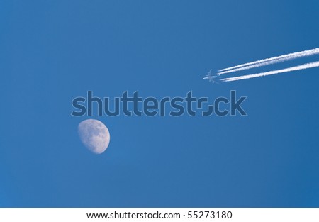 airplane and moon over blue sky