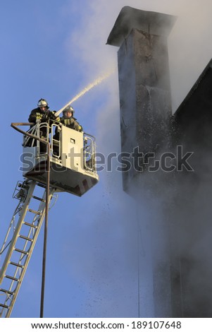 Leninsky Prospekt (Lenin avenue) 28. Moscow. Russia.  A house fire. Firefighters work at height. January 29, 2014