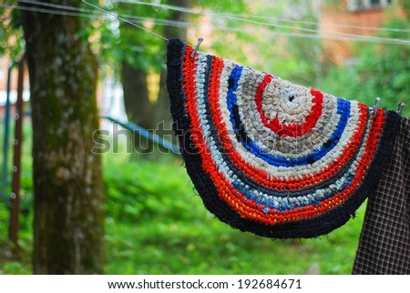 Russian vintage knitted round rug hanging on a rope