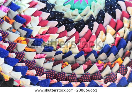 Knitted vintage handmade colorful round rug with triangle pattern