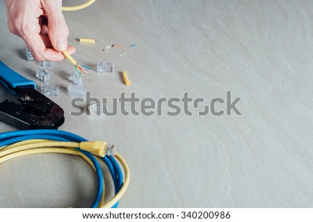 Technician building networking data cable with special tools