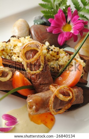 Appetizing dish from meat with a flower