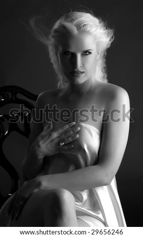 Black and white portrait of a beautiful woman elf sitting on the vintage chair