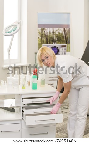 Nurse or doctor is pulling-out drawers
