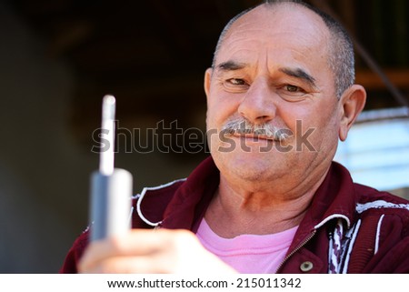 Man holding a meter for measuring how much percent of alcohol is in brandy