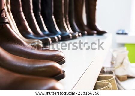 Women leather boots on shells in a store