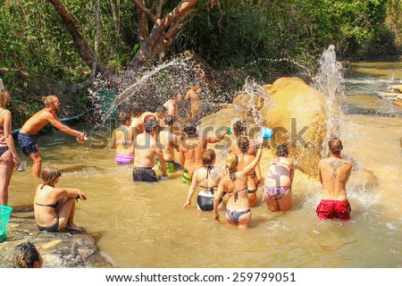 CHIANG MAI, THAILAND - MARCH 9 : People have opportunity to experience the lifestyle of elephants and wash elephant in river. (no hook, no chain, no riding) on MARCH 9, 2015 in Chiang Mai, Thailand.