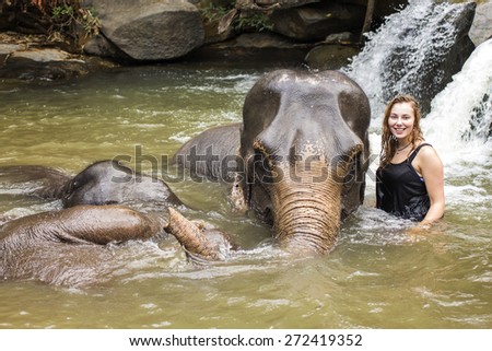 CHIANG MAI, THAILAND - APRIL 25, 2015 : People have opportunity to experience the lifestyle of elephants and bathing with elephant  in river. (no hook, no chain, no riding) in Chiang Mai, Thailand.