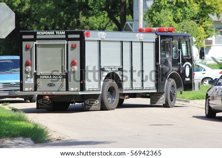 TOPEKA, KS - JULY 10: The Topeka police S.W.A.T. and Hostage Rescue teams respond to a home where a man barricaded himself in his home, threatening harm to himself on July 10, 2010 in Topeka, KS.
