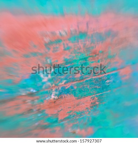 Abstract background scratched and blurred chipped painted surface turquoise, green, blue and peach orange color with grunge feel, swirling blur and copy space. Photo taken with a lensbaby muse lens.