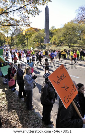 NEW YORK - NOV. 7:  An unidentified man in the crowd holds up a humorous hand-lettered sign in Central Park just past Mile 24 of the 2010 New York City Marathon on Nov. 7, 2010 in New York, New York.