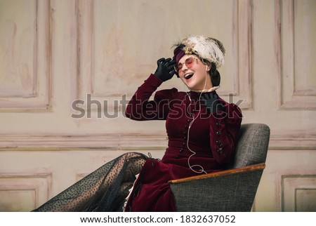Listening to music in earphones. Modern trendy look of Portrait of an Unknown Woman. Retro style, comparison of eras concept. Beautiful caucasian female model like classic art character, old-fashioned