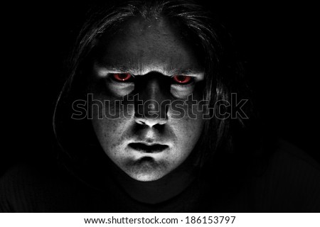 Dark evil face on black background