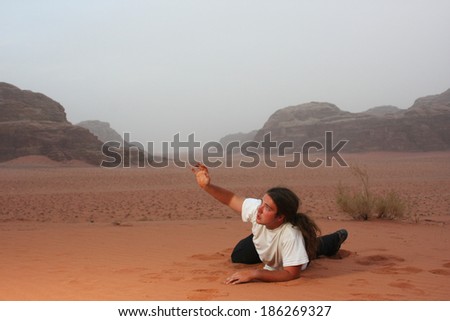 Desperate man in the desert longing for something