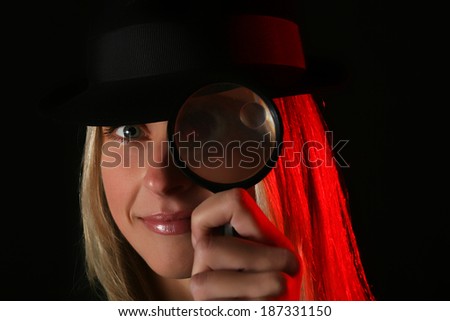 Nice blond female spy with magnifier