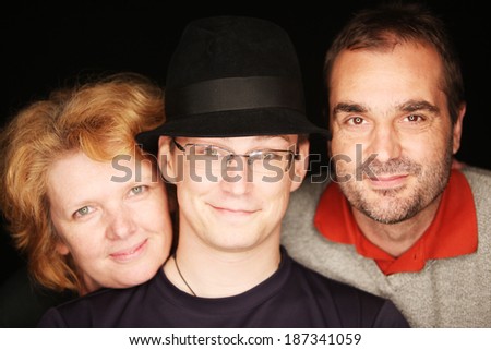 Guy with the hat with his parents (focus on the guy in the middle)