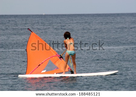 Attractive girl learning to surf