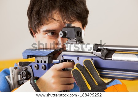 Man training sport shooting with air rifle gun