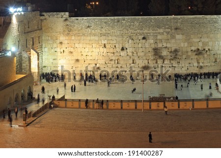 People, mostly soldiers praying at the holiest Jewish site - Western/Wailing wall at night