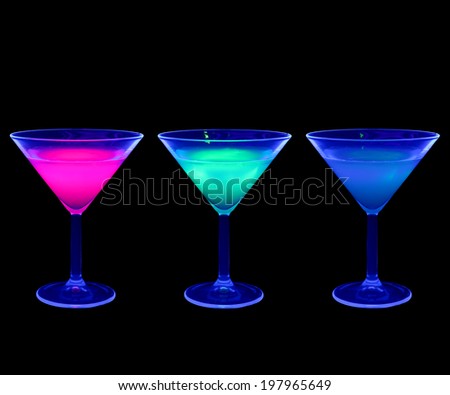 Colorful cocktail glass in UV light (black light)