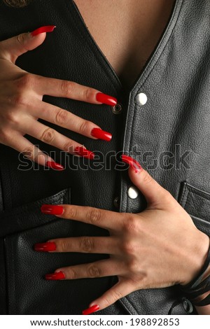Woman with long nails touching man's chest