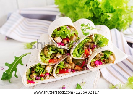 Chicken burrito. Healthy lunch.  Mexican street food fajita tortilla wraps with grilled  chicken fillet and fresh vegetables.