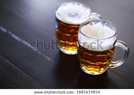 Glass of fresh beer on a wooden table. Lager beer mug on stone table. Top view copy space