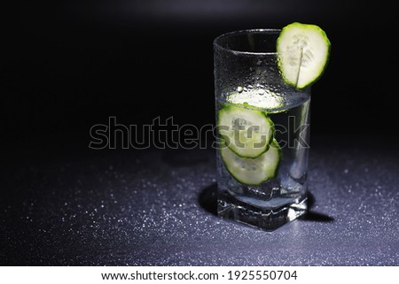 Cucumber water. Drinking water with fresh cucumber. Mineral water. Healthy mineral refreshing water with cucumber.