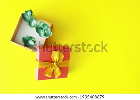 St. patrick\'s day background. Religious Christian Irish celebration. Four-leaf clover symbol of good luck with gift box.